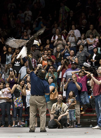 To the delight of a packed house, a bald eagle is displayed to symbolizing the U.S. before the Grand Entry during the Gathering of Nations, on Saturday night, April 30, 2011. The three day event held in Albuquerque, N.M. brought together thousand of spectators, dancers and merchants from all over the U.S. and Canada. © 2011 Gallup Independent / Diego James Robles